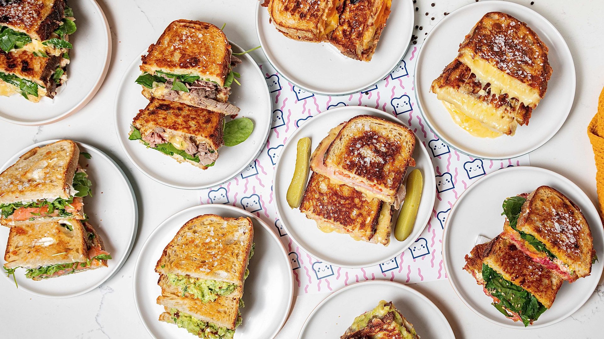 * TOAST IT! * ____________________________________________ TWO CAFES. ONE SIGNATURE.ONE BRAND.____________________________________ ICONIC TOASTIES & SPECIALTY COFFEE.
